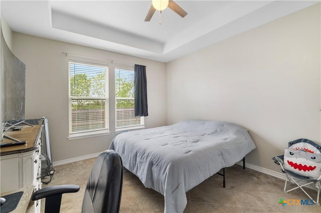 211 Amberglow Ct, Victoria, TX 77904 - bedroom featuring a raised ceiling, baseboards, and a ceiling fan