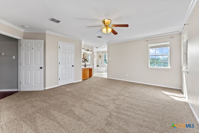 unfurnished bedroom featuring ceiling fan, connected bathroom, carpet, and ornamental molding