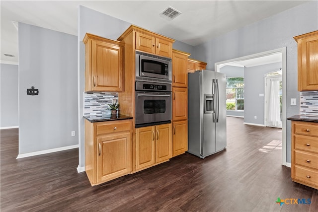 kitchen with backsplash, appliances with stainless steel finishes, and dark hardwood / wood-style floors