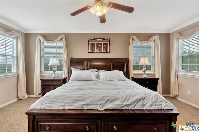 bedroom featuring ceiling fan, multiple windows, light carpet, and crown molding