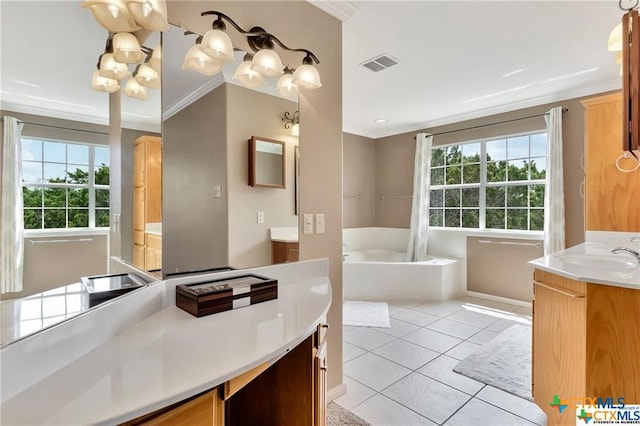 bathroom with a bathtub, a healthy amount of sunlight, tile patterned floors, and an inviting chandelier