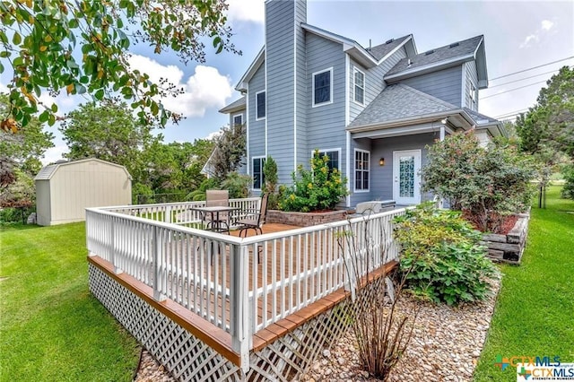 16047 Charlya Dr, Temple, TX 76502 - back of house featuring a shed, a deck, a shingled roof, an outdoor structure, and a yard
