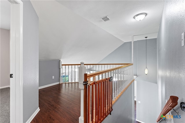 staircase with hardwood / wood-style flooring and vaulted ceiling