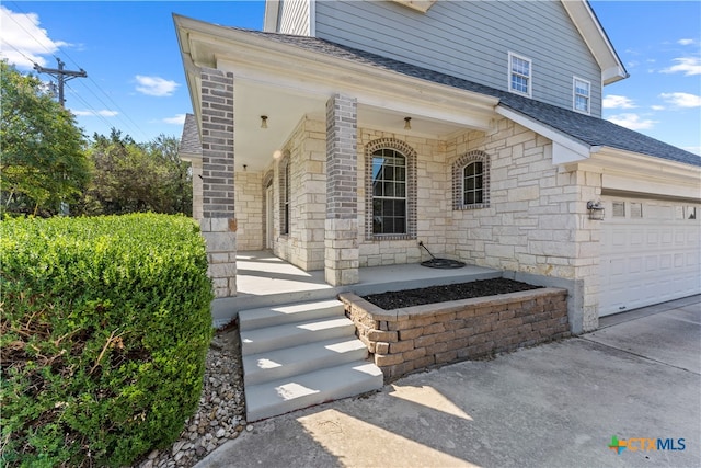 view of front facade with a garage and covered porch