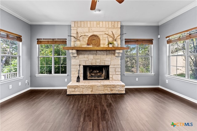 unfurnished living room featuring a stone fireplace, dark wood-type flooring, and ceiling fan