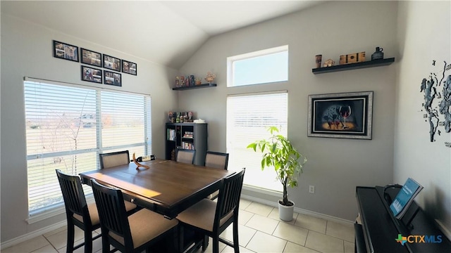 dining area featuring lofted ceiling and light tile patterned flooring