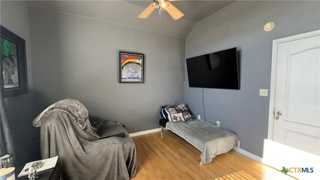 bedroom featuring hardwood / wood-style floors, ceiling fan, and lofted ceiling