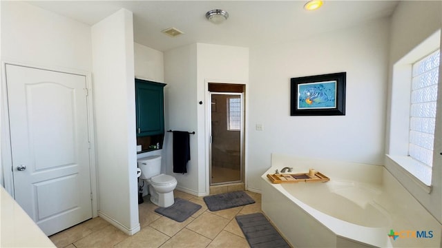 bathroom featuring tile patterned flooring, toilet, and independent shower and bath