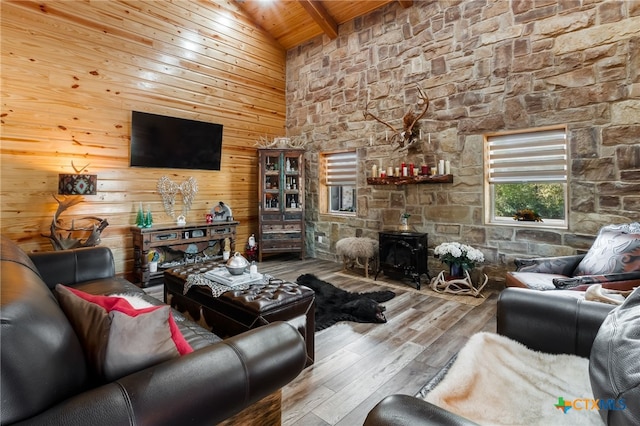 living room with high vaulted ceiling, wood-type flooring, a wood stove, wooden ceiling, and beam ceiling