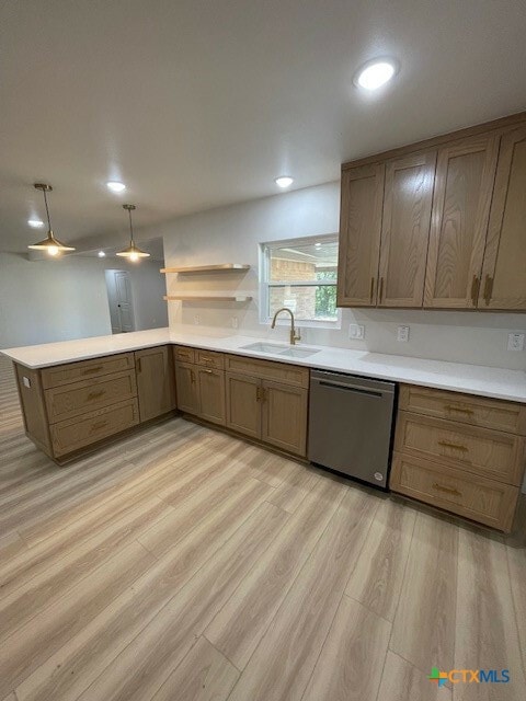 kitchen featuring dishwasher, light hardwood / wood-style floors, kitchen peninsula, and sink