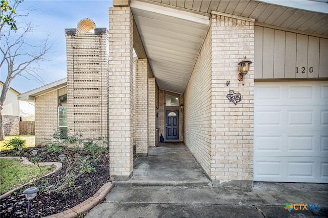 view of exterior entry with a garage