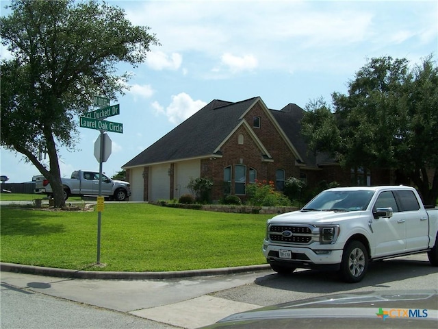 101 Laurel Oak Cir, Cuero, TX 77954 - view of front of property featuring a front lawn and brick siding