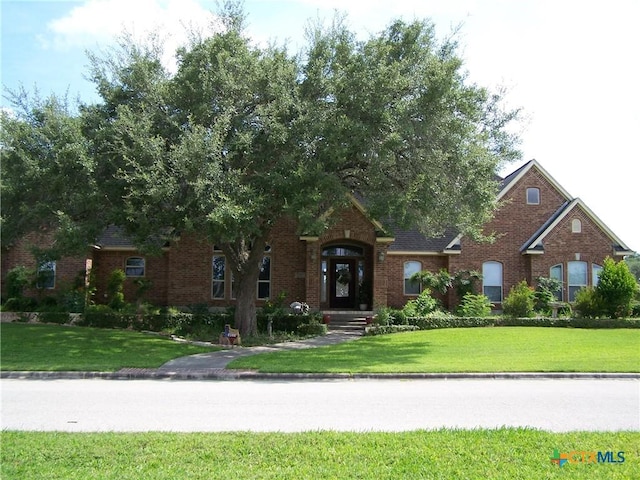 101 Laurel Oak Cir, Cuero, TX 77954 - view of front of property featuring brick siding and a front lawn