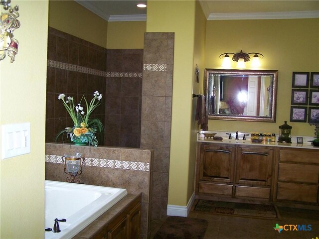 101 Laurel Oak Cir, Cuero, TX 77954 - bathroom with a garden tub, vanity, tile patterned flooring, ornamental molding, and baseboards