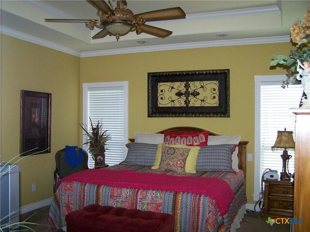 101 Laurel Oak Cir, Cuero, TX 77954 - bedroom featuring a tray ceiling, baseboards, crown molding, and a ceiling fan