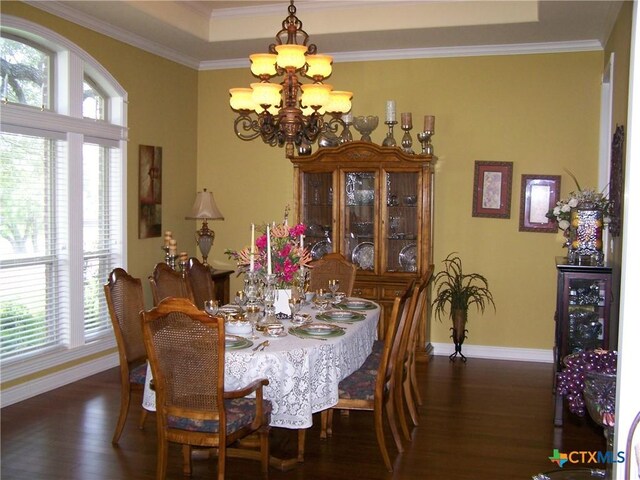 101 Laurel Oak Cir, Cuero, TX 77954 - dining area with a chandelier, baseboards, wood finished floors, healthy amount of natural light, and ornamental molding
