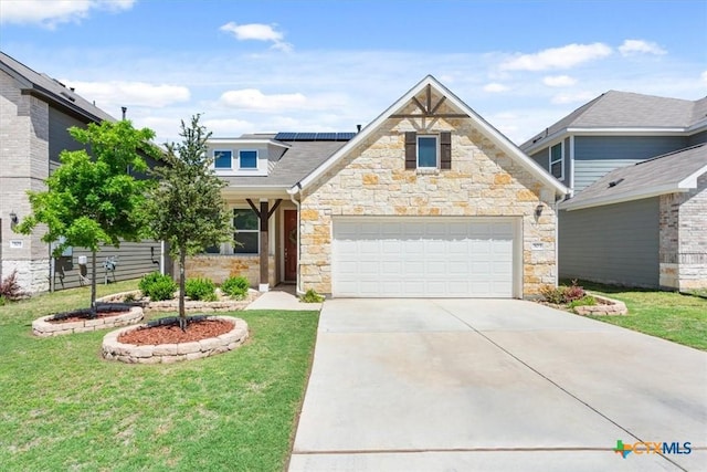 303 Blackbear Dr, Hutto, TX 78634 - view of front of house with stone siding, solar panels, driveway, and a front yard