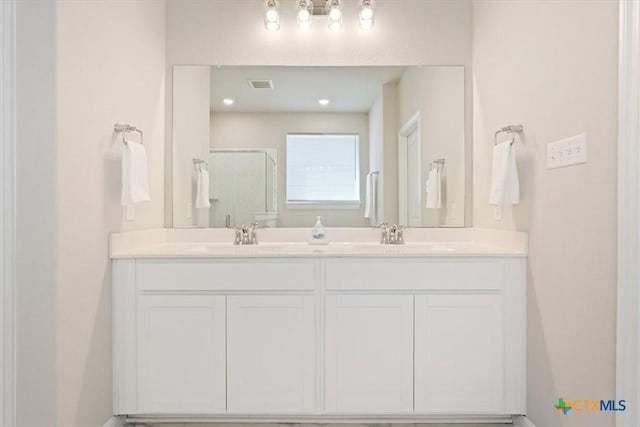 303 Blackbear Dr, Hutto, TX 78634 - full bathroom featuring a stall shower and double vanity