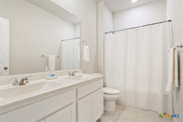 303 Blackbear Dr, Hutto, TX 78634 - bathroom featuring toilet, tile patterned floors, double vanity, and curtained shower