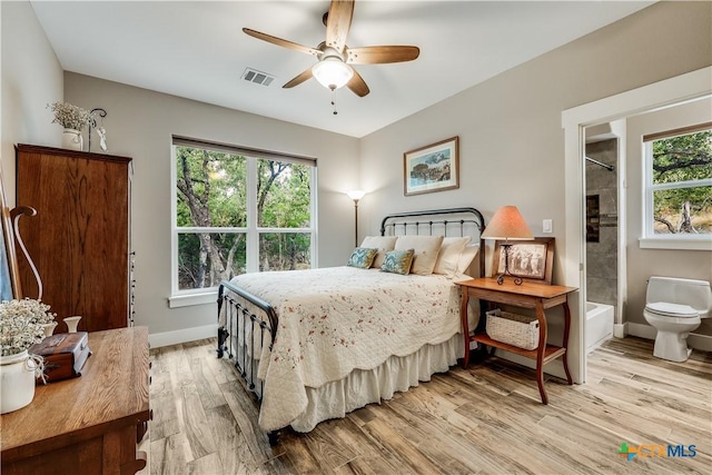 bedroom featuring ceiling fan, ensuite bathroom, and light hardwood / wood-style floors