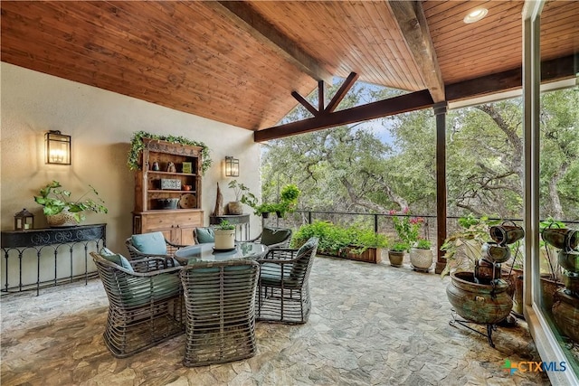 sunroom featuring vaulted ceiling with beams and wood ceiling