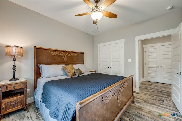 bedroom featuring ceiling fan, a closet, and hardwood / wood-style flooring