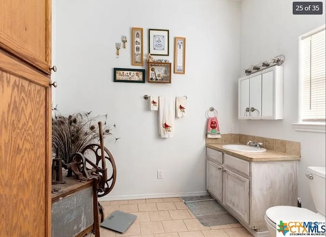 256 County Road 481, Gonzales, TX 78629 - bathroom with tile patterned flooring, toilet, baseboards, and vanity