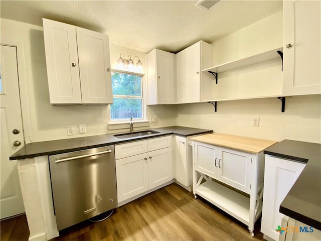 kitchen featuring white cabinetry, dishwasher, sink, dark hardwood / wood-style floors, and a textured ceiling