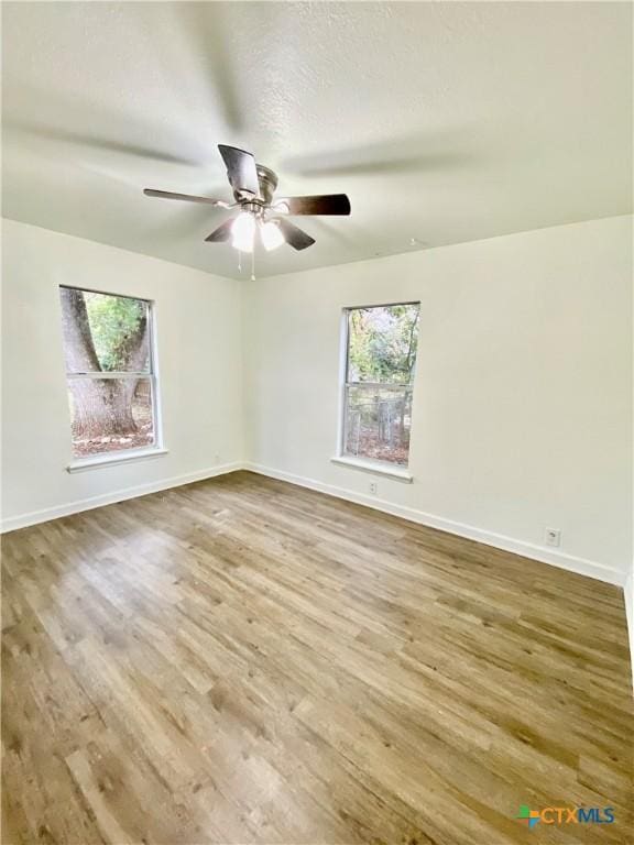 unfurnished room featuring ceiling fan and hardwood / wood-style floors