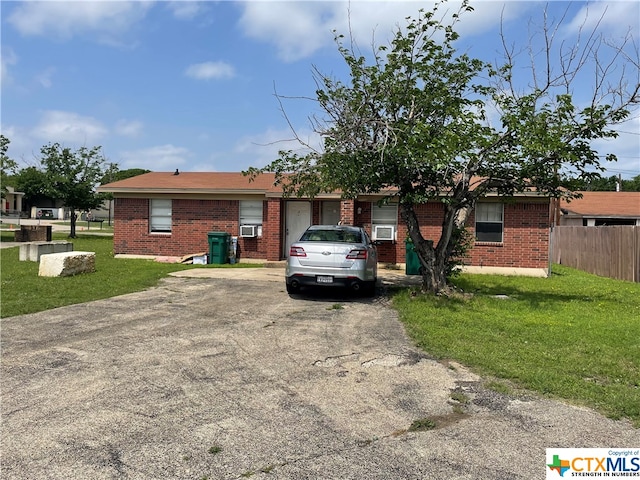 ranch-style home with a front lawn