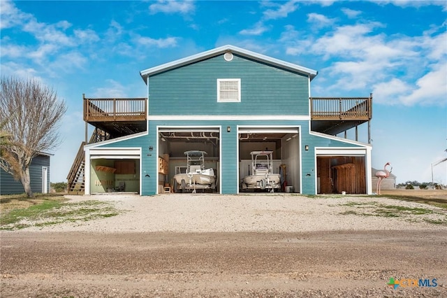 view of front of house with a garage and a deck