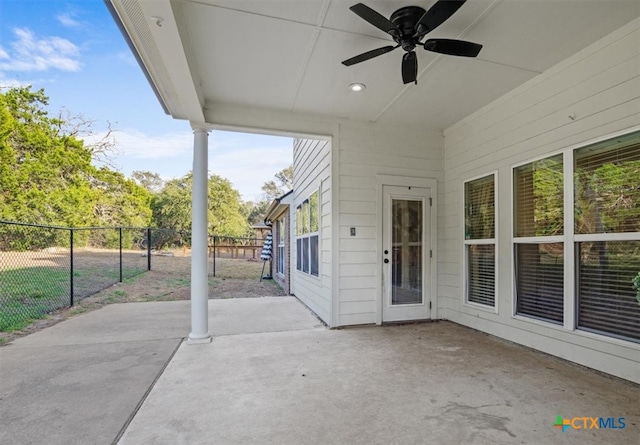 view of patio with fence and a ceiling fan