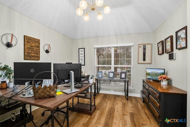 office featuring vaulted ceiling, a notable chandelier, wood finished floors, and baseboards