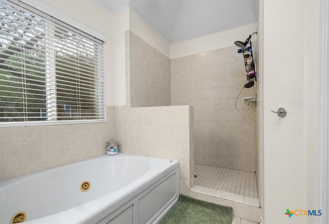 bathroom with a whirlpool tub, plenty of natural light, a walk in shower, and tile patterned flooring