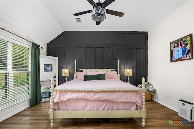 bedroom with lofted ceiling, wood finished floors, a ceiling fan, visible vents, and baseboards