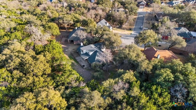 drone / aerial view with a forest view and a residential view