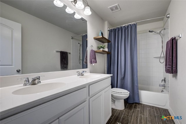 2844 Klein Way, New Braunfels, TX 78130 - full bathroom featuring wood finish floors, double vanity, shower / bath combination with curtain, and toilet