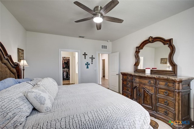 2844 Klein Way, New Braunfels, TX 78130 - bedroom featuring a ceiling fan, a walk in closet, and baseboards