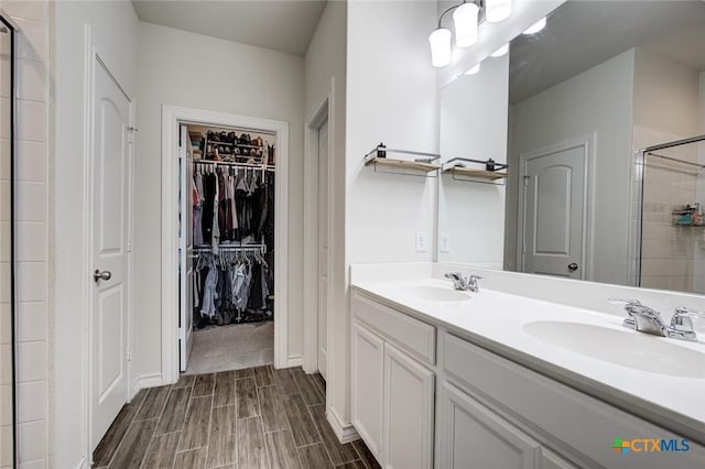 2844 Klein Way, New Braunfels, TX 78130 - full bath featuring a stall shower, wood tiled floors, double vanity, and a spacious closet