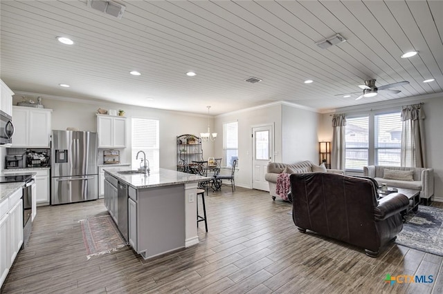 2844 Klein Way, New Braunfels, TX 78130 - kitchen with appliances with stainless steel finishes, open floor plan, ornamental molding, a sink, and an island with sink