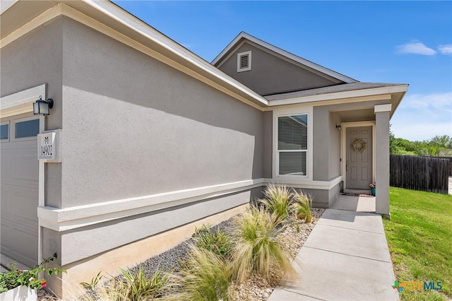14902 Ardilla, San Antonio, TX 78217 - doorway to property with fence, stucco siding, and an attached garage