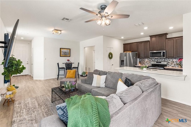 14902 Ardilla, San Antonio, TX 78217 - living room with a ceiling fan, light wood-style flooring, baseboards, and recessed lighting