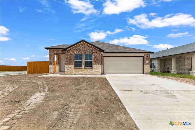 702 Stonevalley Rd, Temple, TX 76502 - single story home featuring a garage, driveway, brick siding, stone siding, and a shingled roof