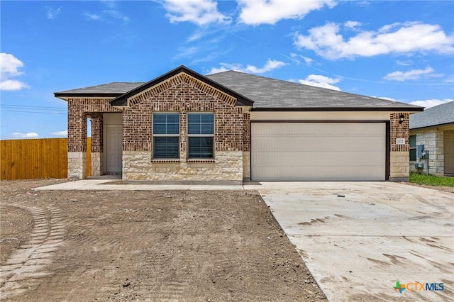 702 Stonevalley Rd, Temple, TX 76502 - single story home with an attached garage, brick siding, concrete driveway, stone siding, and roof with shingles