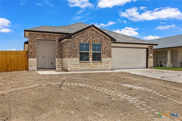 702 Stonevalley Rd, Temple, TX 76502 - ranch-style house featuring brick siding, an attached garage, concrete driveway, and stone siding