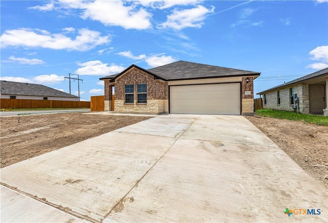 702 Stonevalley Rd, Temple, TX 76502 - single story home with an attached garage, concrete driveway, brick siding, and stone siding