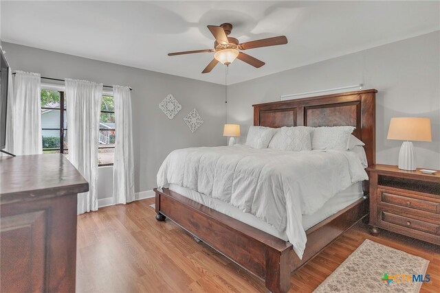 bedroom featuring light hardwood / wood-style floors and ceiling fan