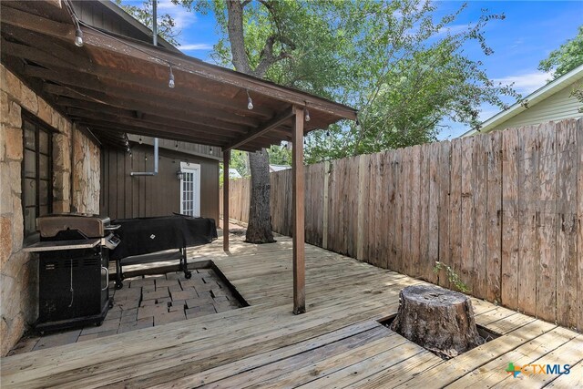 wooden terrace with a grill