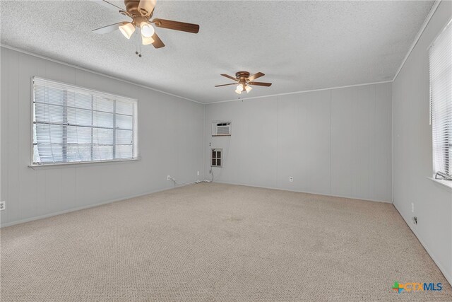 empty room featuring ornamental molding, a textured ceiling, carpet flooring, and ceiling fan