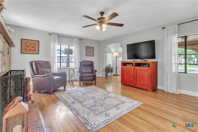 living room featuring ceiling fan and light hardwood / wood-style flooring